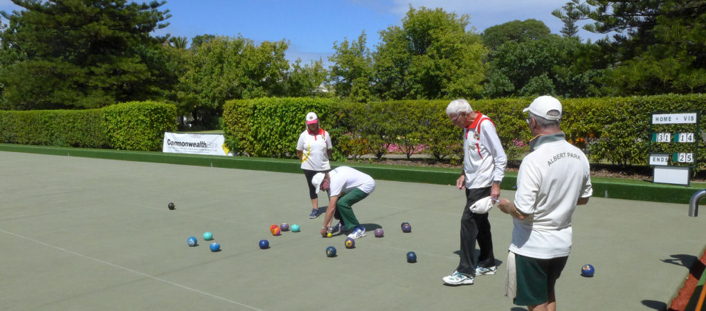 Lawn bowler about to measure to determined shot count